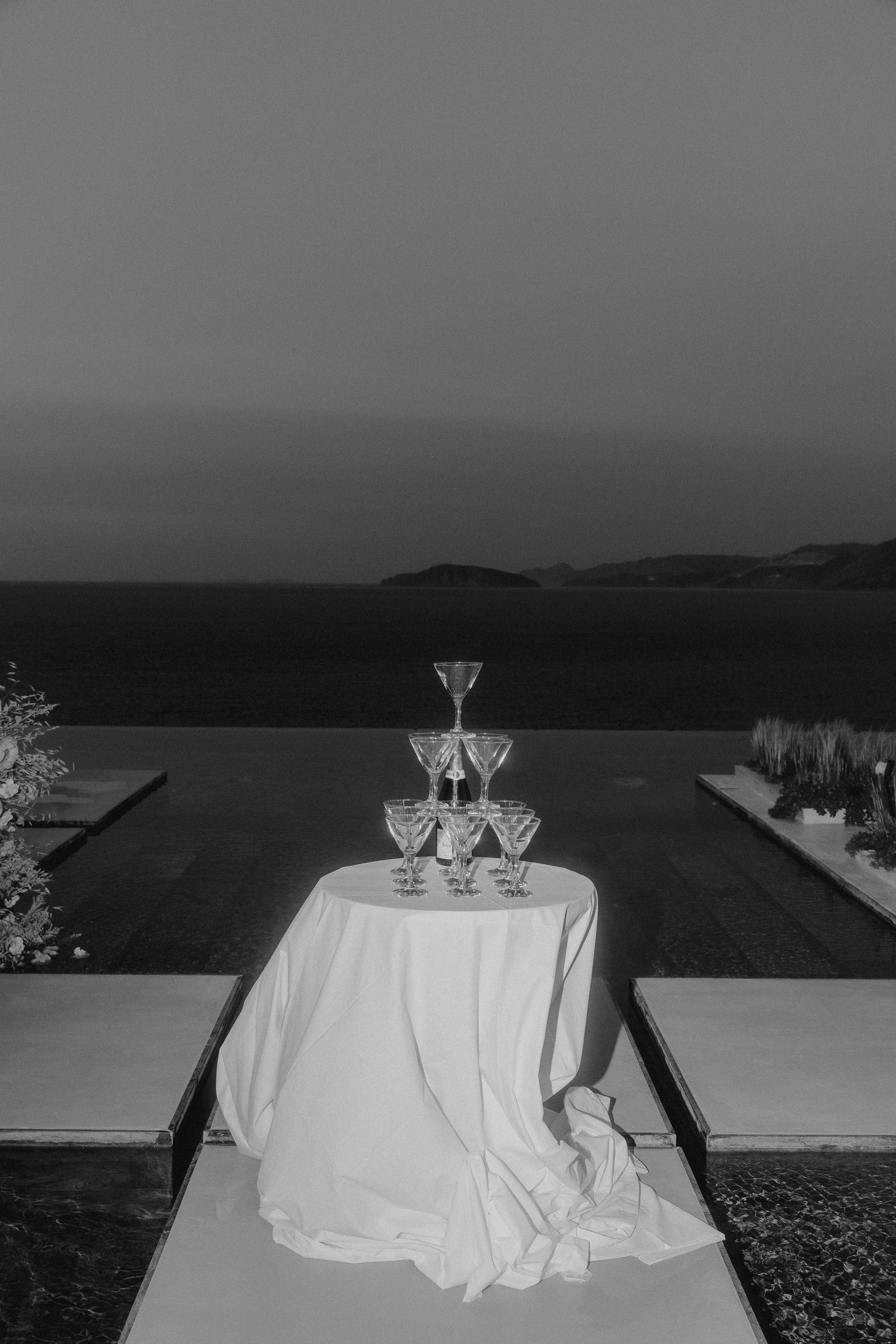 Decorative glass pyramid on a table with ocean view