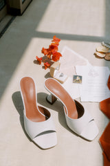 white amina muaddi shoes wedding inviotation and wedding ring flat lay